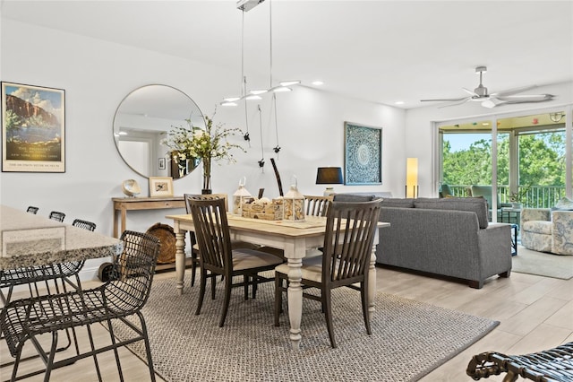 dining space with ceiling fan and light hardwood / wood-style floors