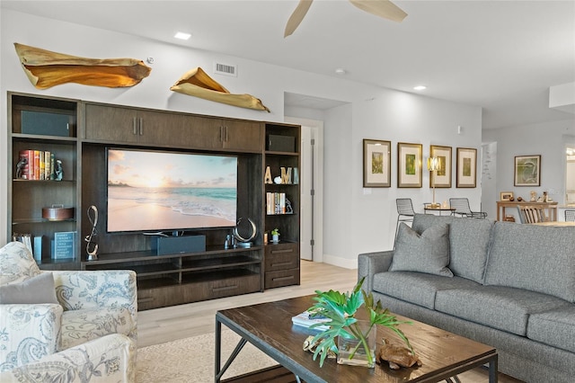 living room with light wood-type flooring and ceiling fan