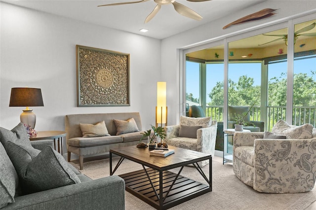 carpeted living room with ceiling fan