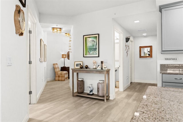 hall with light hardwood / wood-style floors