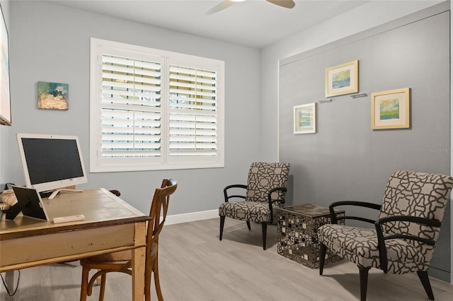 office area with light wood-type flooring and ceiling fan