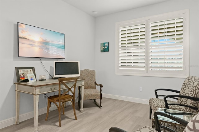 office with light hardwood / wood-style flooring