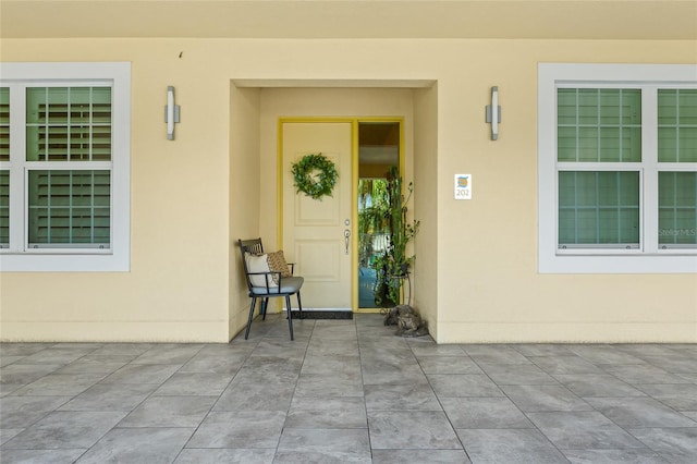 view of exterior entry featuring a patio