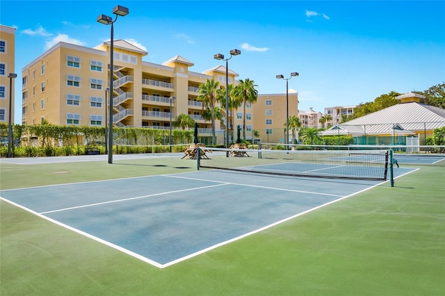 view of tennis court with basketball hoop