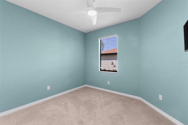 spare room with ceiling fan and carpet