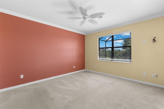 unfurnished room featuring ornamental molding, ceiling fan, and light colored carpet