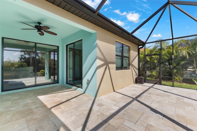 view of patio with glass enclosure and ceiling fan