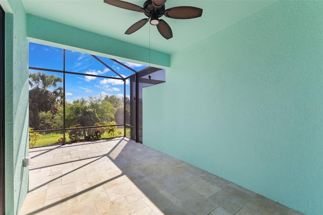 unfurnished sunroom with ceiling fan