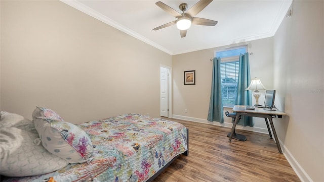 bedroom featuring ornamental molding, ceiling fan, and hardwood / wood-style flooring