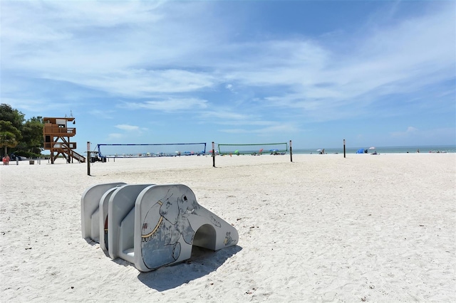 view of home's community with a view of the beach, a water view, and a playground