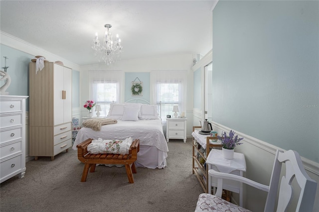 carpeted bedroom featuring crown molding, vaulted ceiling, and a chandelier