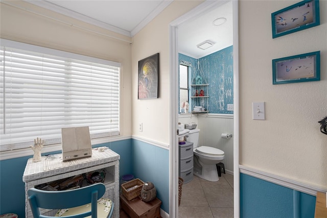 bathroom with crown molding, toilet, and tile patterned flooring