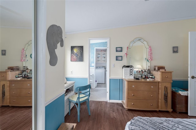 bedroom with washer / clothes dryer, ornamental molding, dark hardwood / wood-style floors, and vaulted ceiling