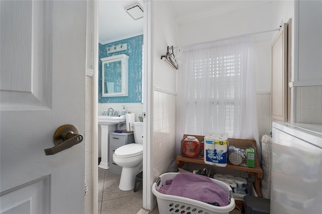 bathroom with tile walls, toilet, and tile patterned floors