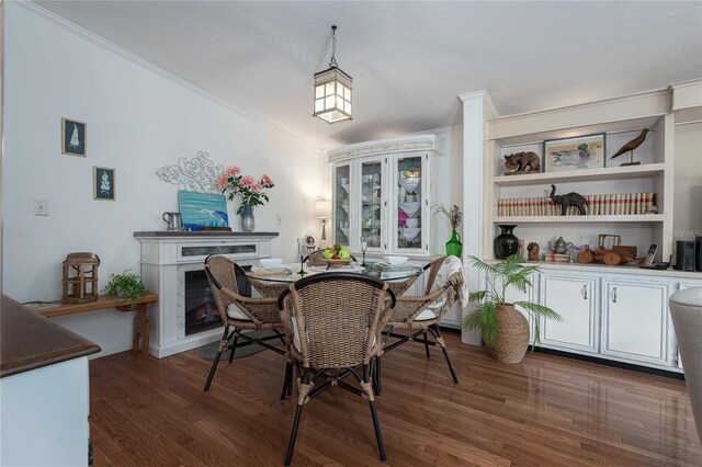 dining space with crown molding and dark wood-type flooring