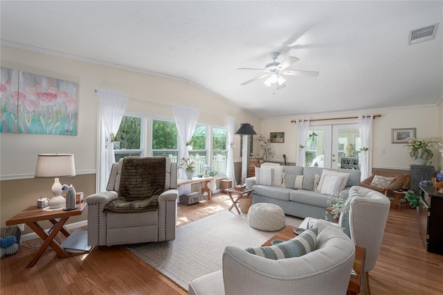 living room with ornamental molding, vaulted ceiling, hardwood / wood-style floors, and ceiling fan