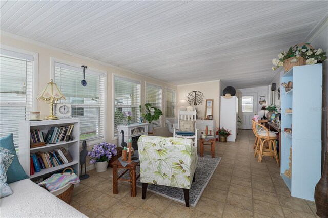 living room with crown molding and a wealth of natural light