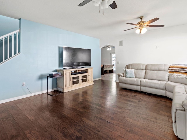 living room with ceiling fan and dark wood-type flooring