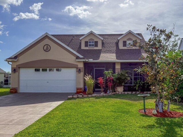 7209 49th Pl E, Palmetto, FL 34221 - view of front of home featuring a garage, stucco siding, roof with shingles, a front yard, and concrete driveway