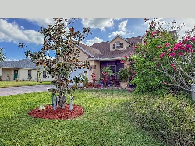 7209 49th Pl E, Palmetto, FL 34221 - view of front of property featuring a shingled roof, driveway, a front yard, and stucco siding