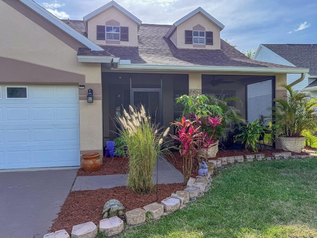 7209 49th Pl E, Palmetto, FL 34221 - view of front of property featuring a shingled roof, a front lawn, stucco siding, a sunroom, and a garage