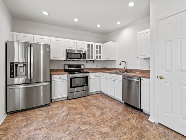 7209 49th Pl E, Palmetto, FL 34221 - kitchen featuring recessed lighting, white cabinetry, stainless steel appliances, and a sink