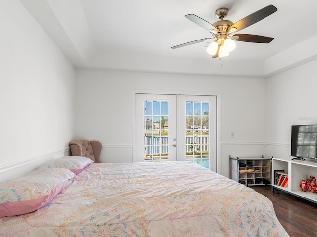 7209 49th Pl E, Palmetto, FL 34221 - bedroom with a tray ceiling, a ceiling fan, access to exterior, dark wood-style flooring, and french doors