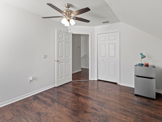 7209 49th Pl E, Palmetto, FL 34221 - bedroom with visible vents, freestanding refrigerator, wood finished floors, and lofted ceiling