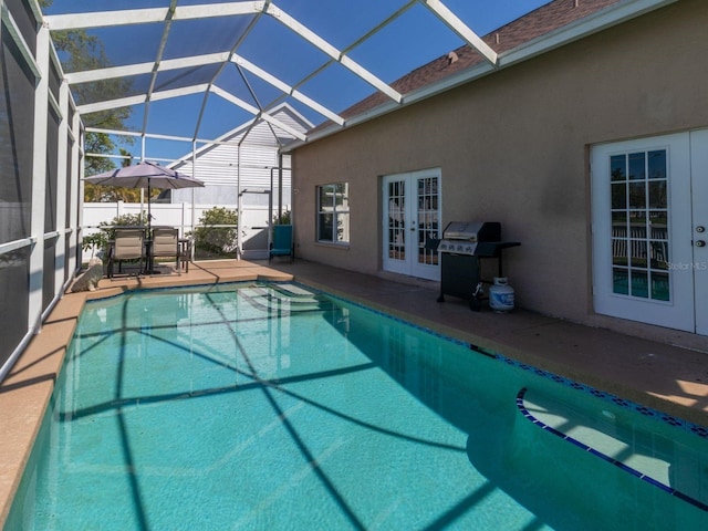 7209 49th Pl E, Palmetto, FL 34221 - view of swimming pool featuring a fenced in pool, a patio, grilling area, french doors, and glass enclosure