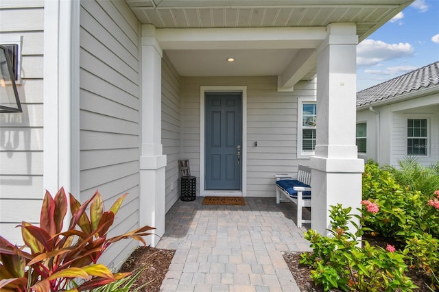 view of exterior entry with covered porch