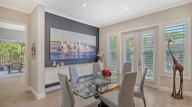 dining space with light wood-style flooring, baseboards, and a healthy amount of sunlight
