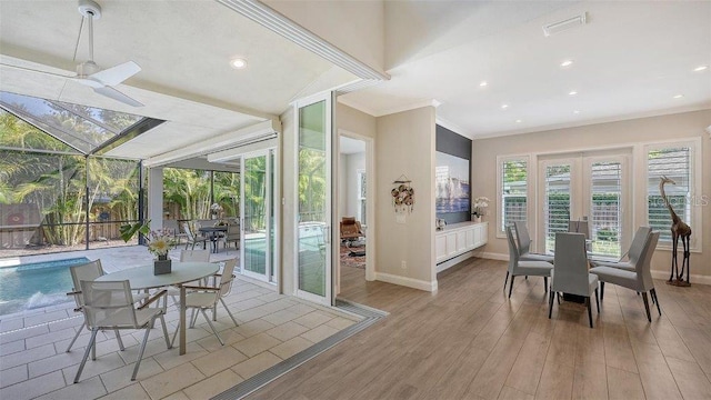dining space featuring french doors, crown molding, wood finished floors, and baseboards