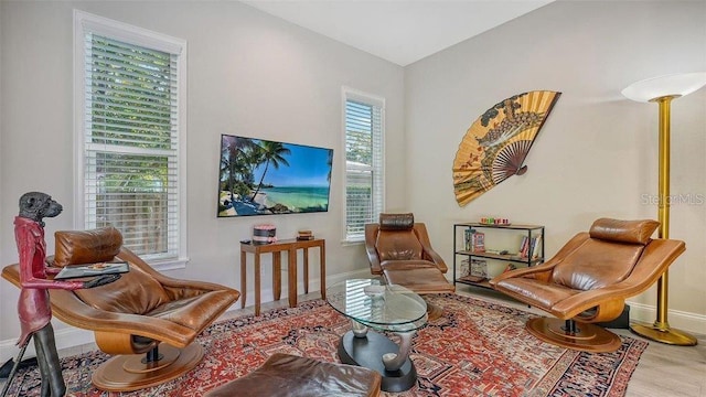 sitting room with wood finished floors and baseboards