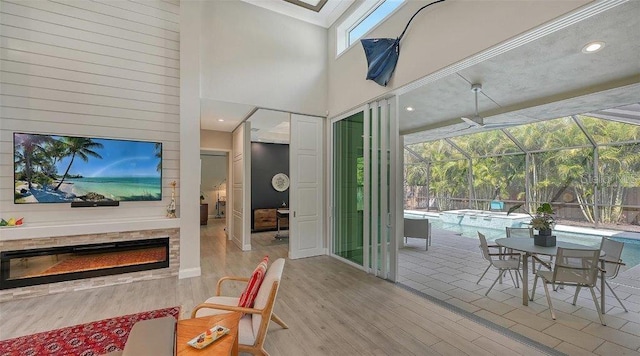 entryway with light hardwood / wood-style floors and a towering ceiling