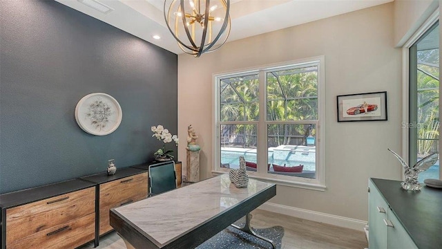 home office with baseboards, light wood-type flooring, an inviting chandelier, and recessed lighting
