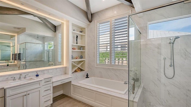 bathroom featuring a garden tub, a marble finish shower, built in shelves, and vanity