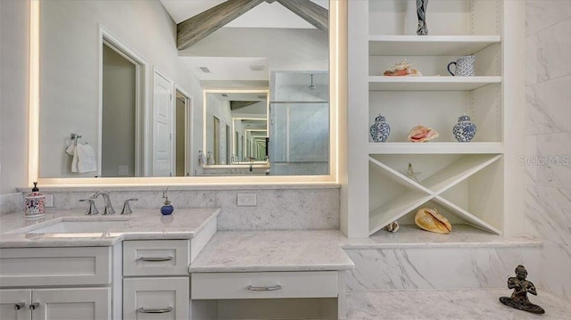 bathroom featuring built in features, vanity, and visible vents