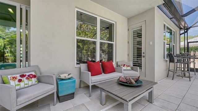 view of patio / terrace featuring glass enclosure