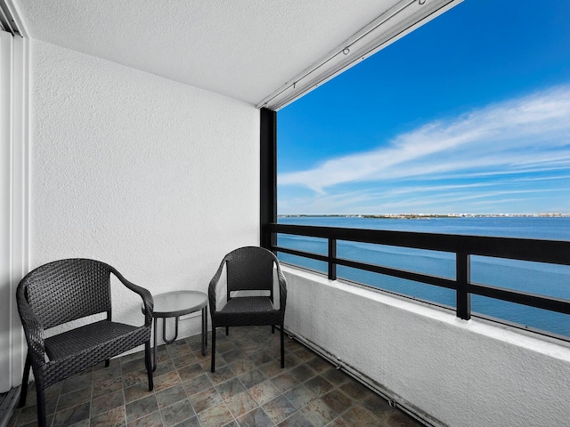 balcony featuring a water view