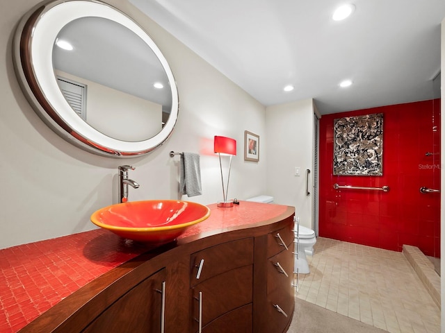 bathroom with tile patterned flooring, vanity, and toilet