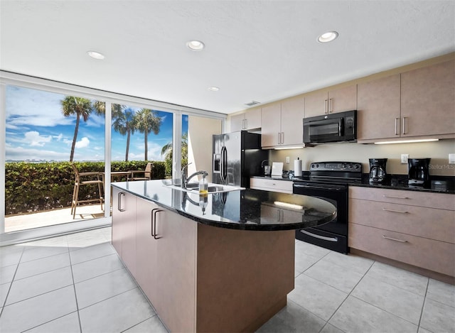 kitchen featuring dark stone countertops, black appliances, light tile patterned floors, and sink