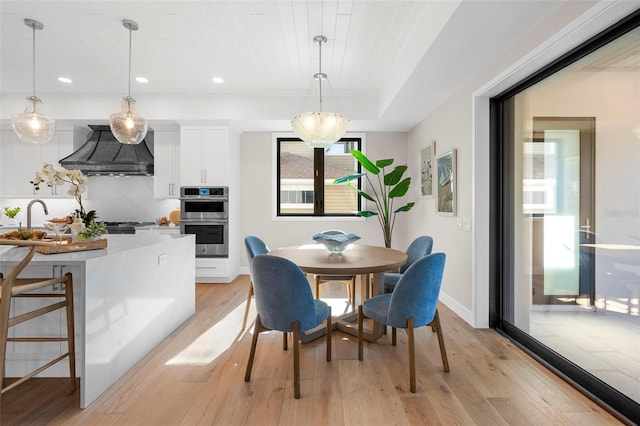 dining space with light hardwood / wood-style floors