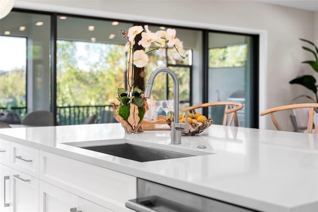 kitchen featuring white cabinets and sink