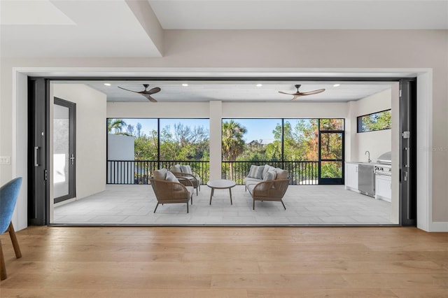 unfurnished sunroom with ceiling fan