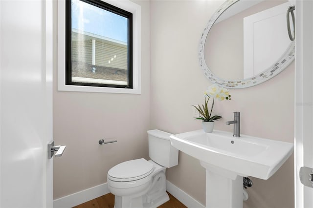 bathroom with hardwood / wood-style floors and toilet