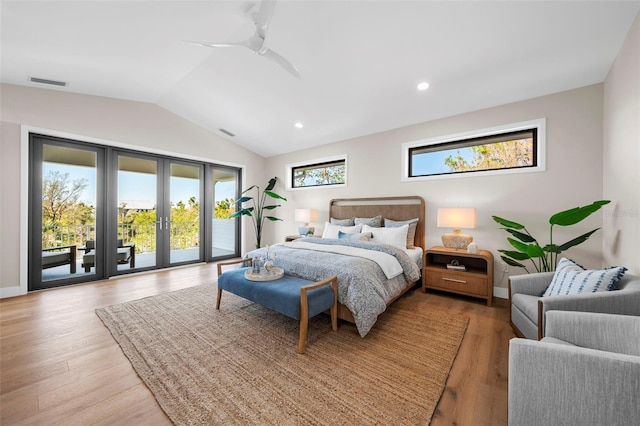 bedroom with hardwood / wood-style floors, ceiling fan, access to exterior, and multiple windows