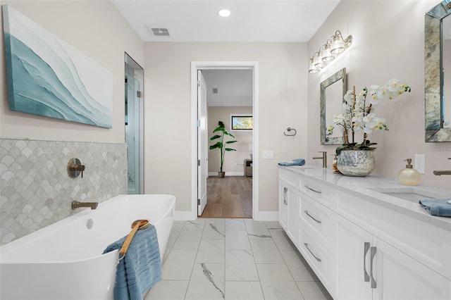 bathroom featuring a tub and vanity