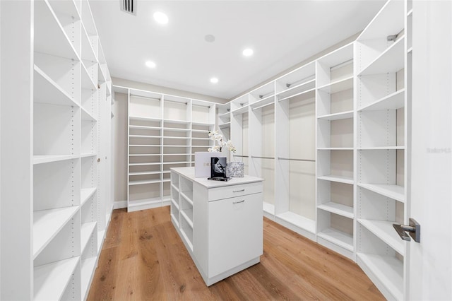 spacious closet with light hardwood / wood-style floors