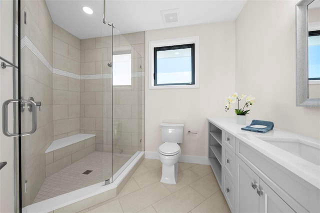 bathroom with toilet, vanity, tile patterned floors, and walk in shower