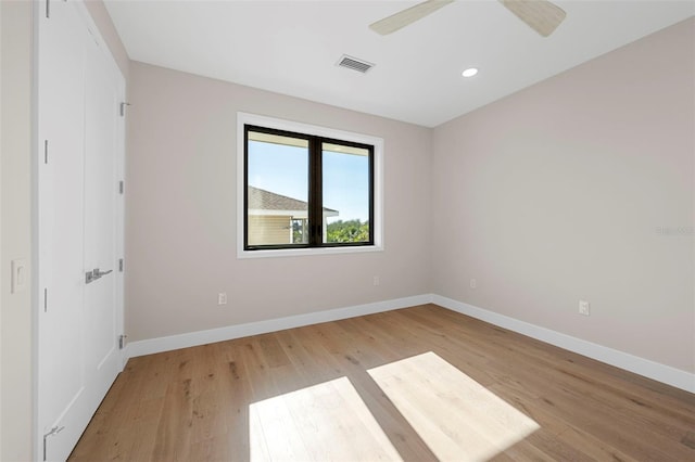 spare room featuring ceiling fan and light hardwood / wood-style flooring